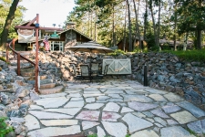In-ground flagstone patio with loose rock retaining wall