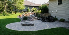Grey-blue radial pattern backyard patio with raised fire pit