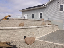 Retaining wall with stairway on side of house