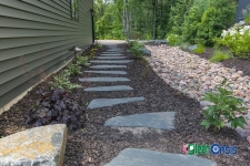 stone path with mulch and rock near side of house